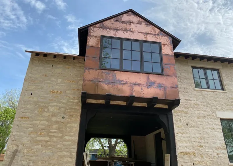 Copper metal panel facade on a stone building for Roof Repair in Jacksonville